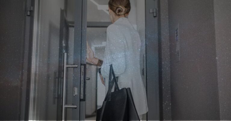 Woman opening door to office space.